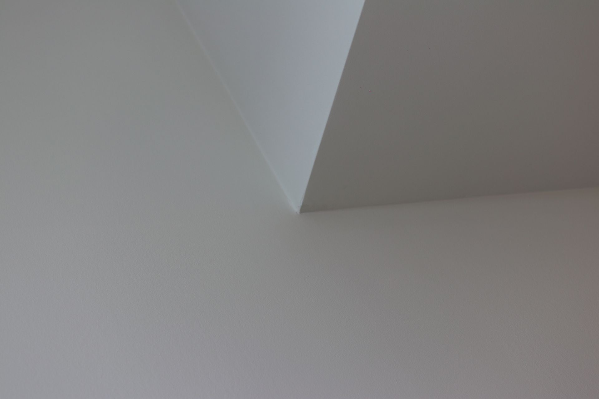a close up of a white wall with a corner .