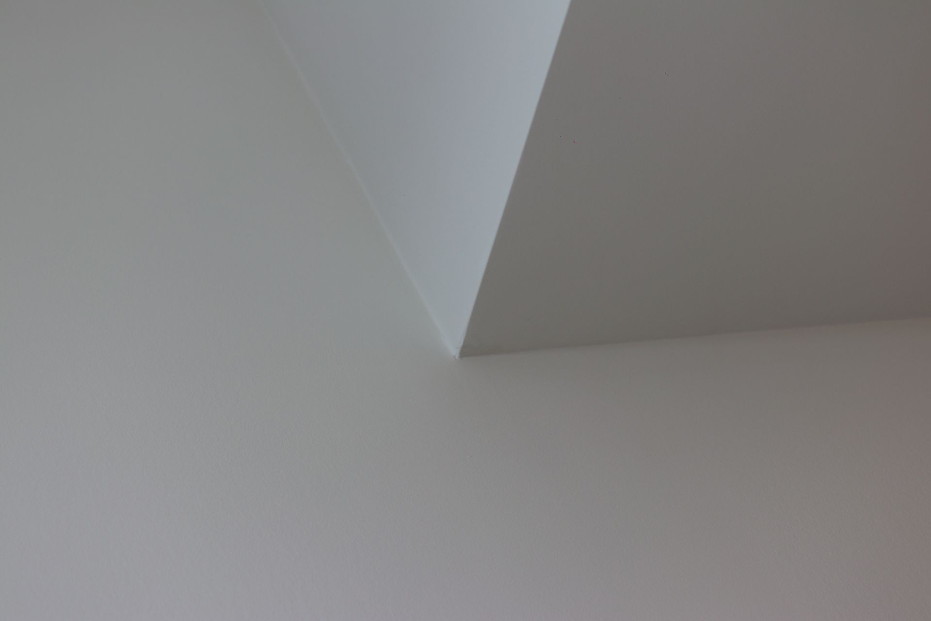 a close up of a white wall with a corner .