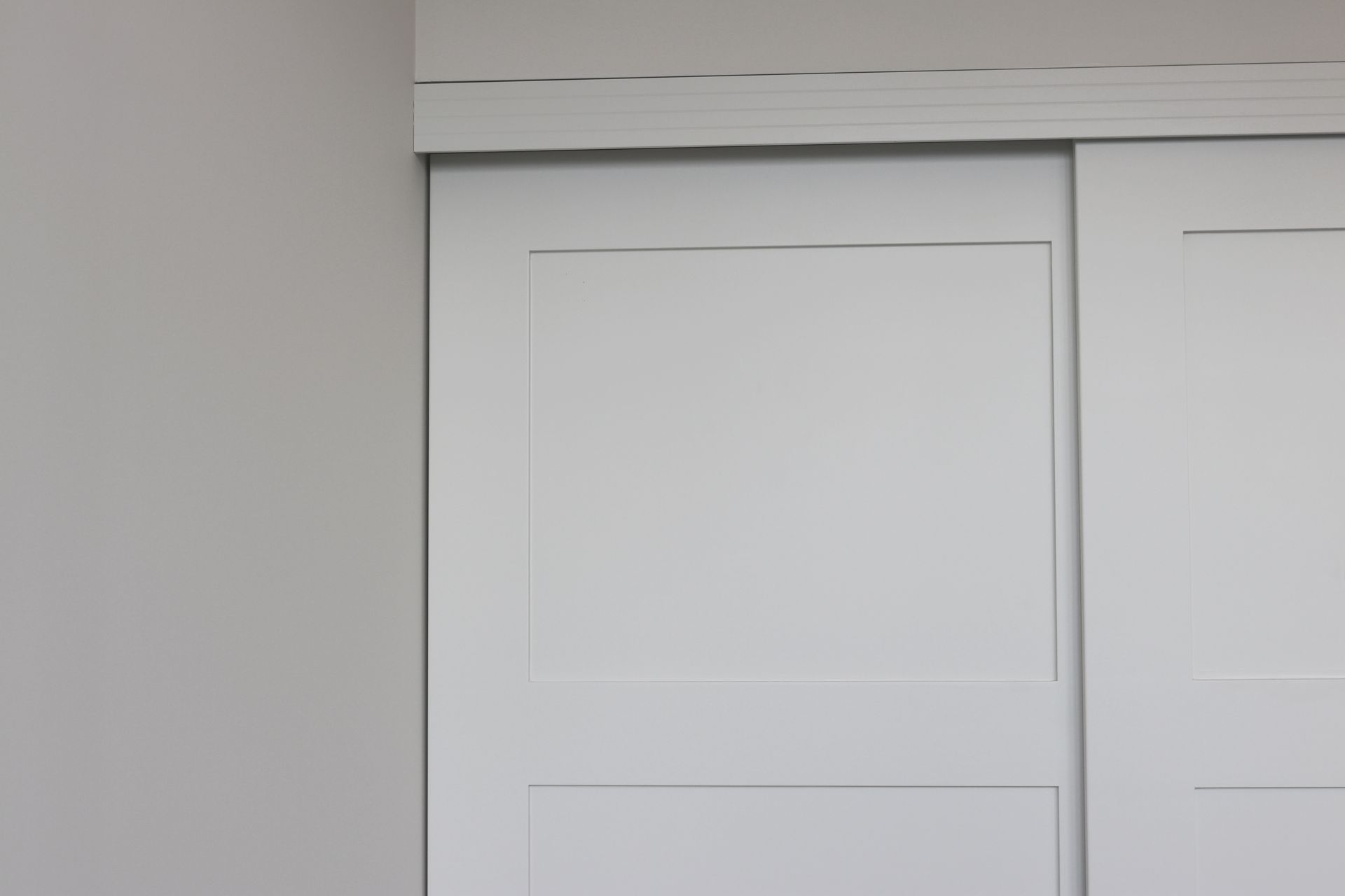 a close up of a white sliding door in a room .