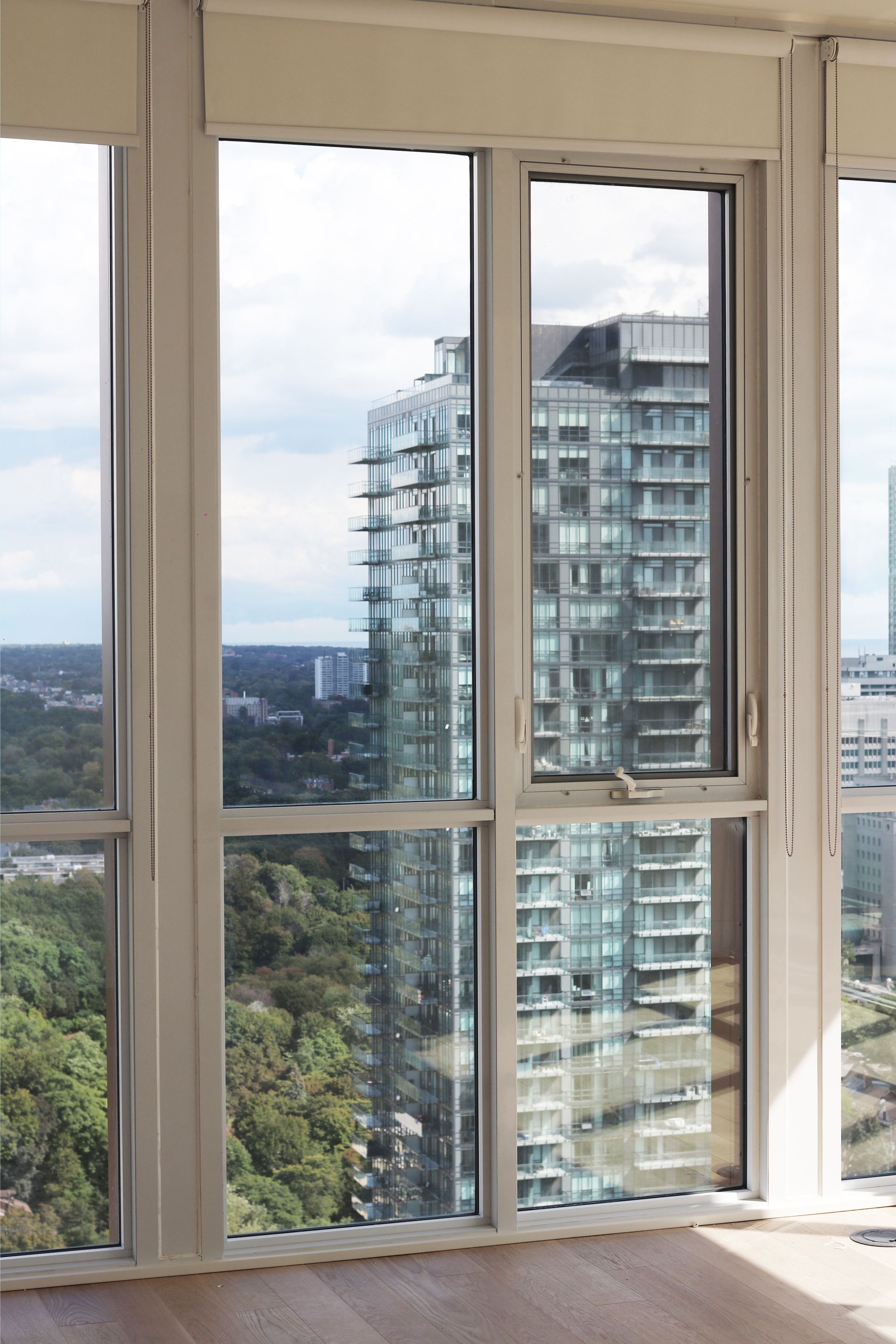 a room with lots of windows and a view of a city
