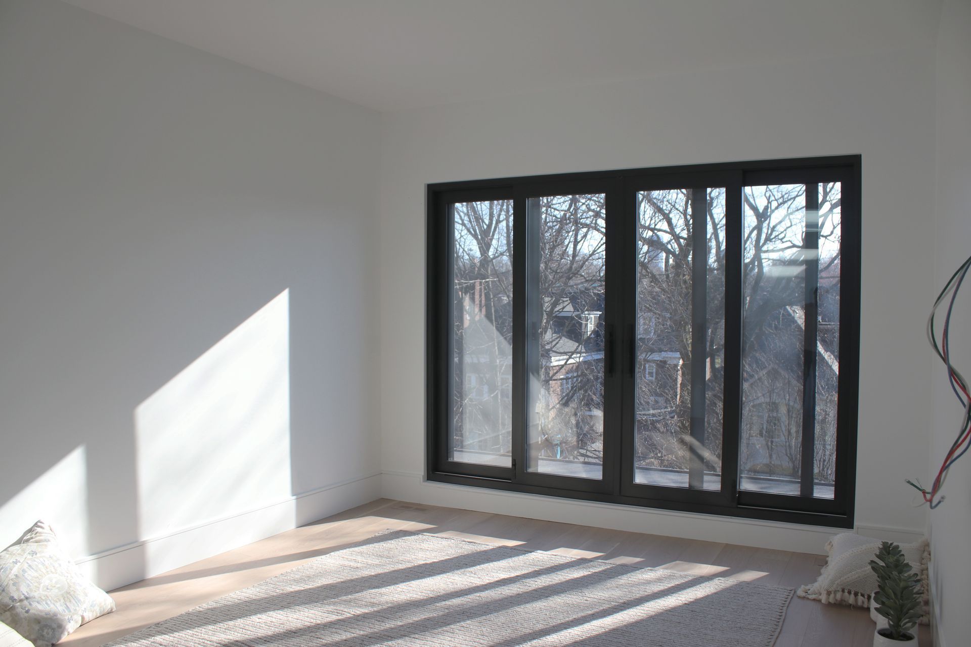 an empty room with a lot of windows and trees in the background .
