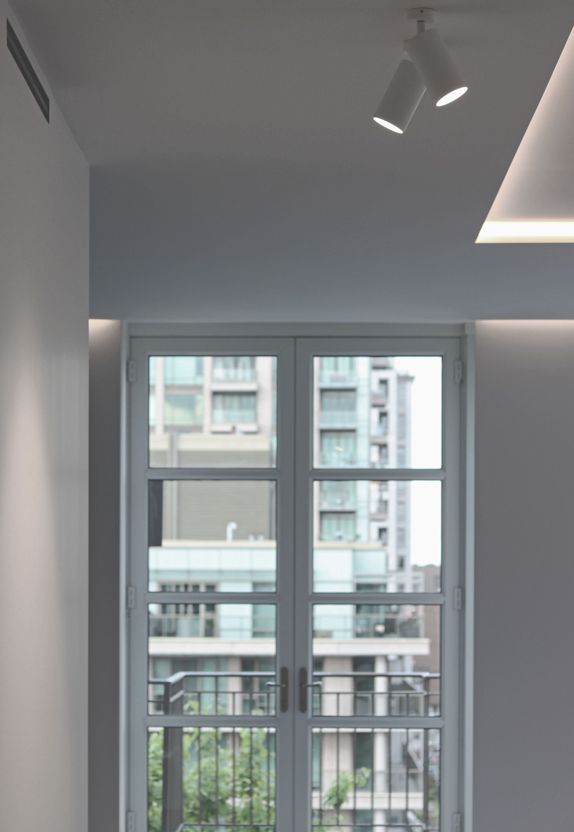 a room with a large window and a balcony