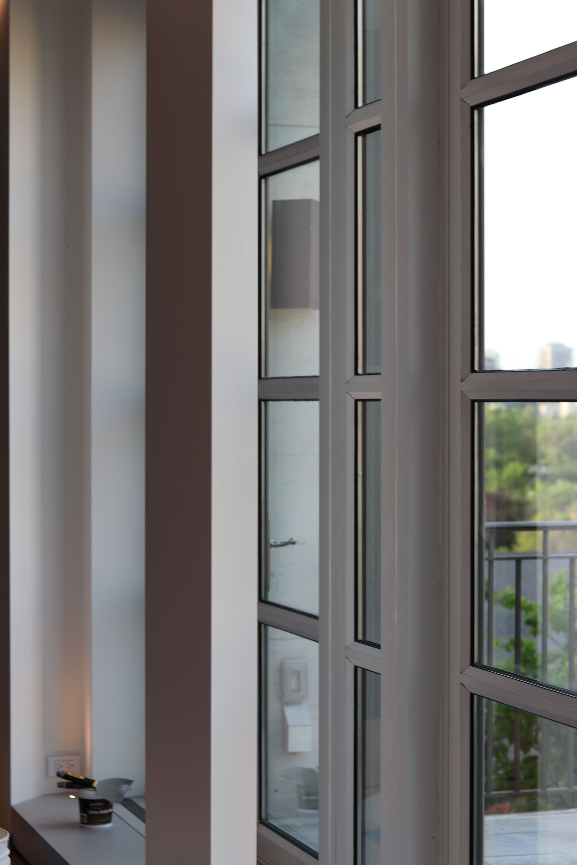 a room with a lot of windows and a balcony