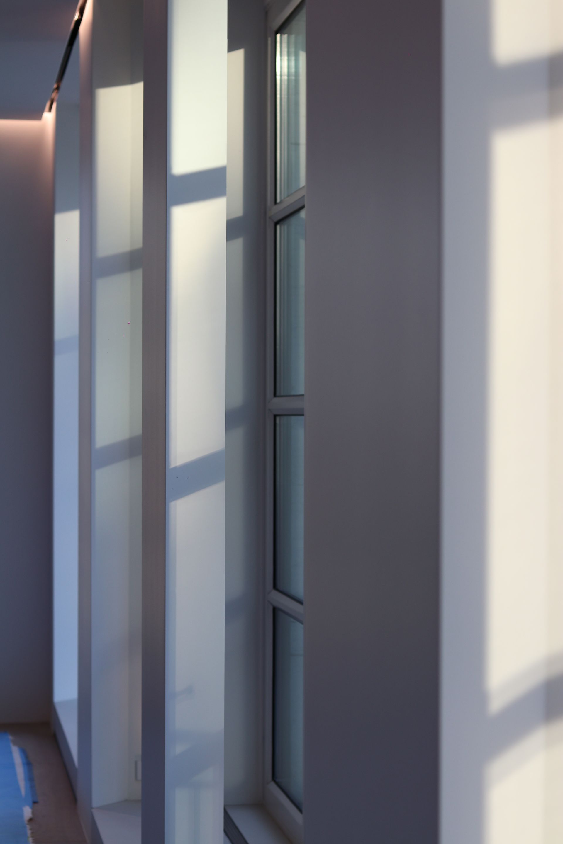 a hallway with a window and a pool in the background