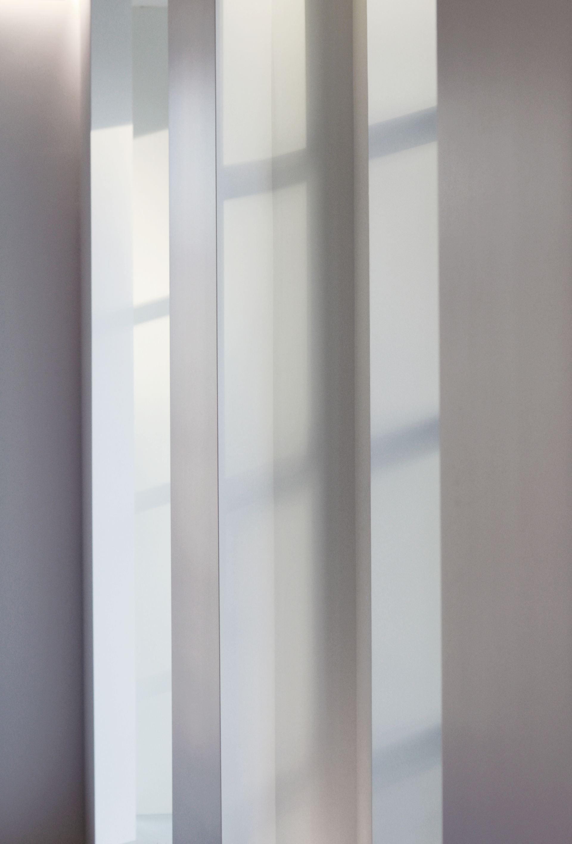 a blurred image of a room with a sliding glass door and a window .