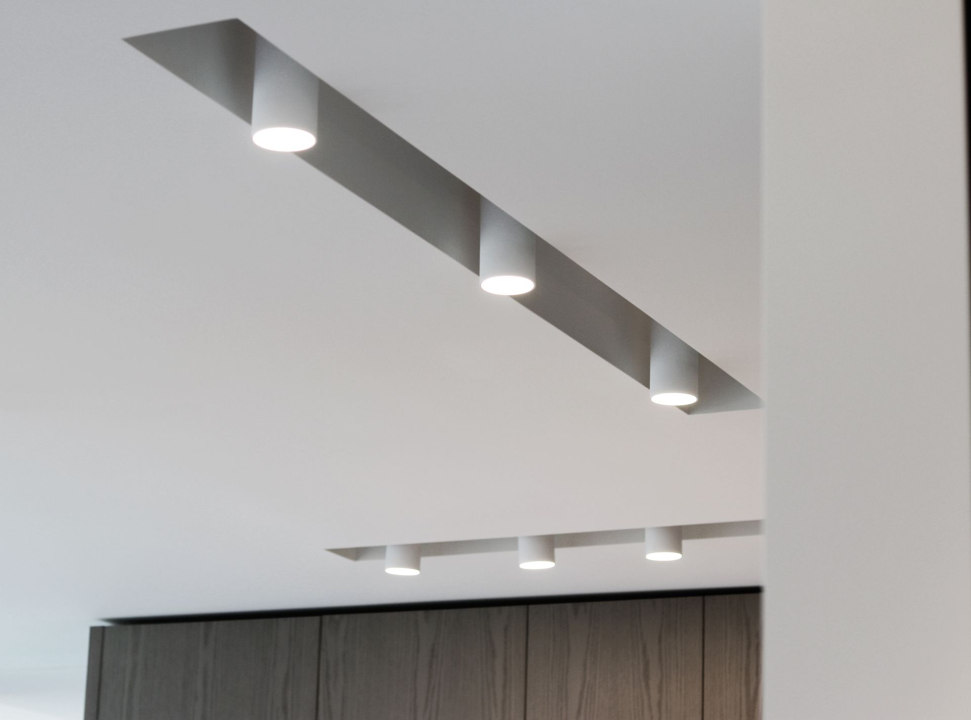 a ceiling with a row of lights hanging from it