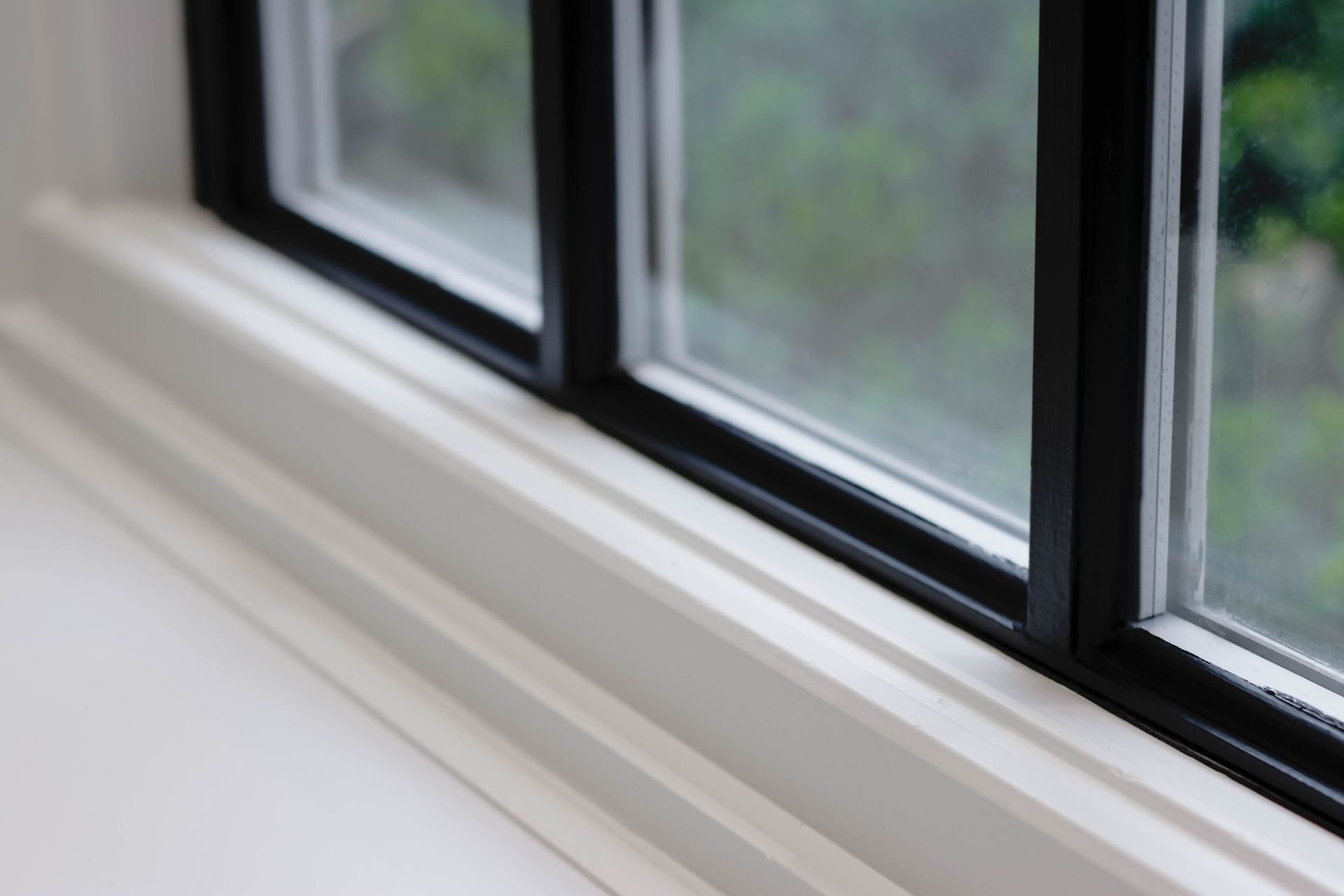 a close up of a window with black trim in a room .