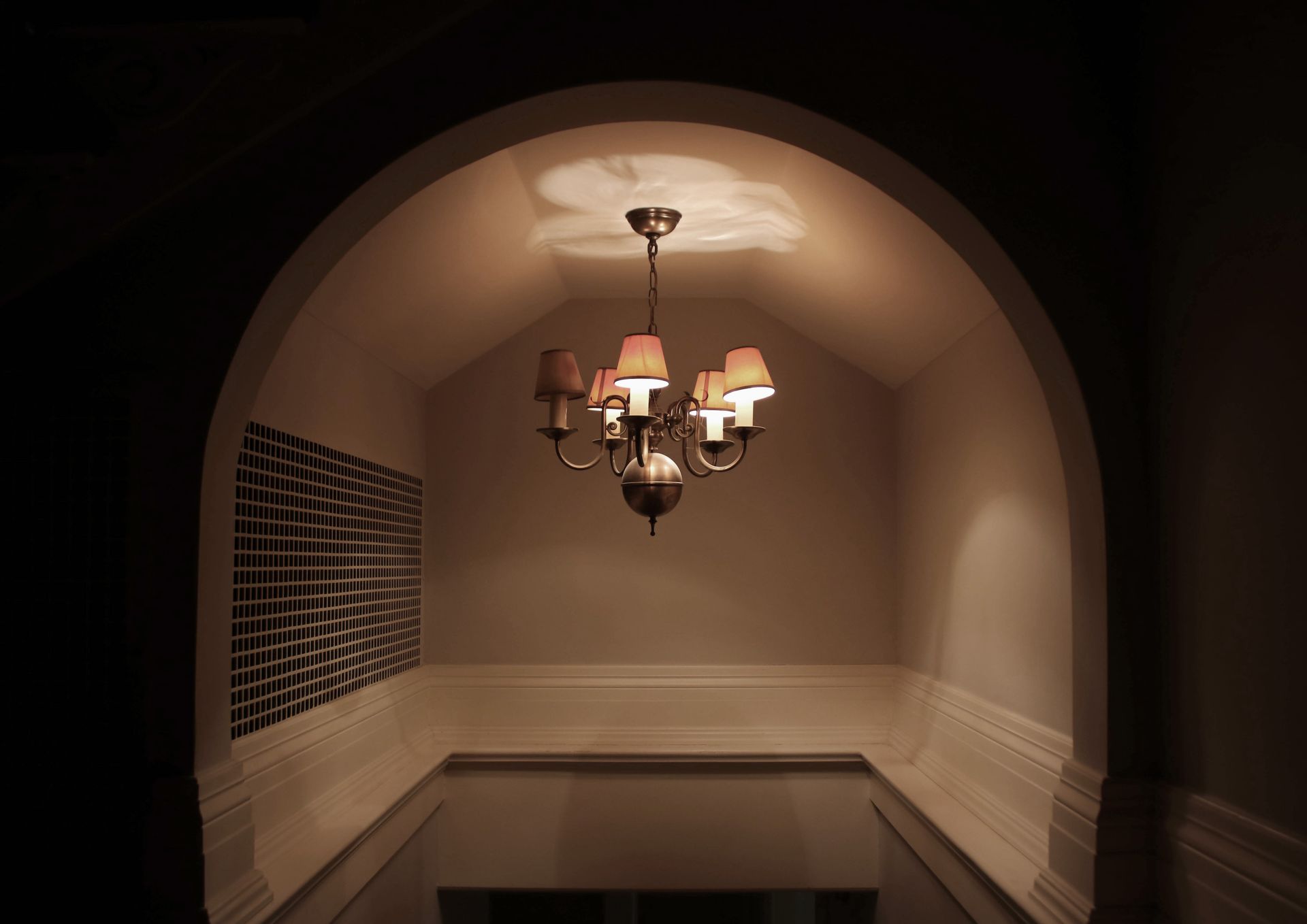 a chandelier is hanging from the ceiling in a dark room