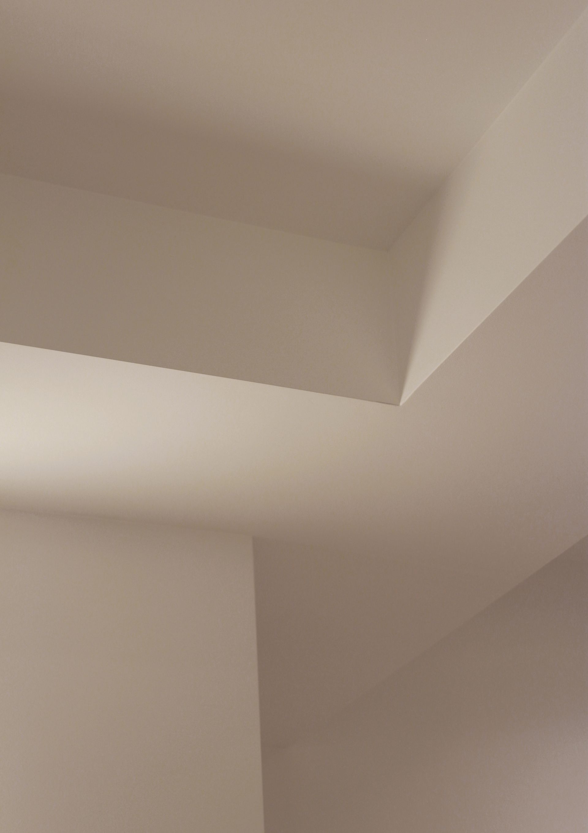 a close up of a white wall and ceiling in a room .