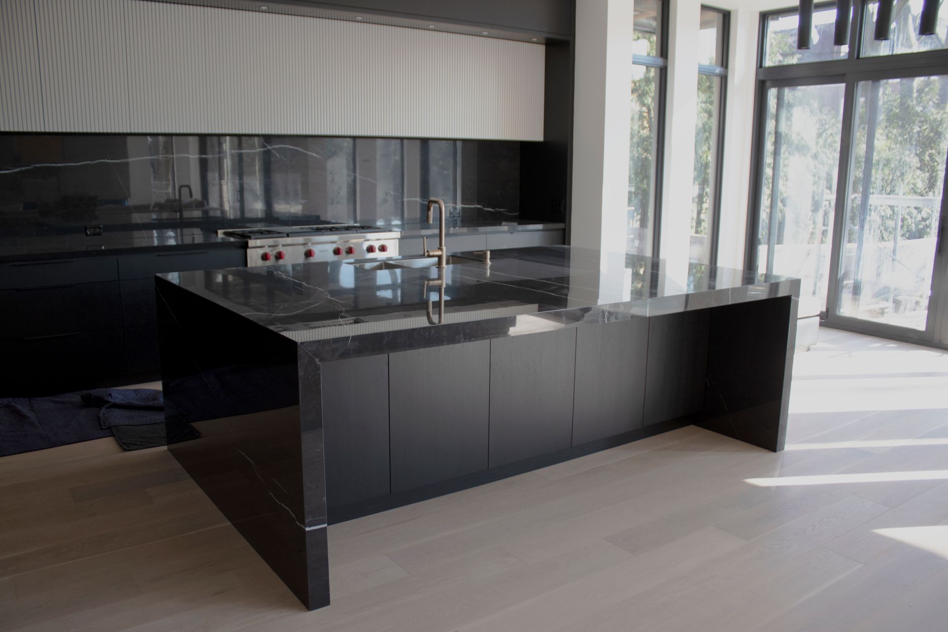 there is a large island in the middle of the kitchen .