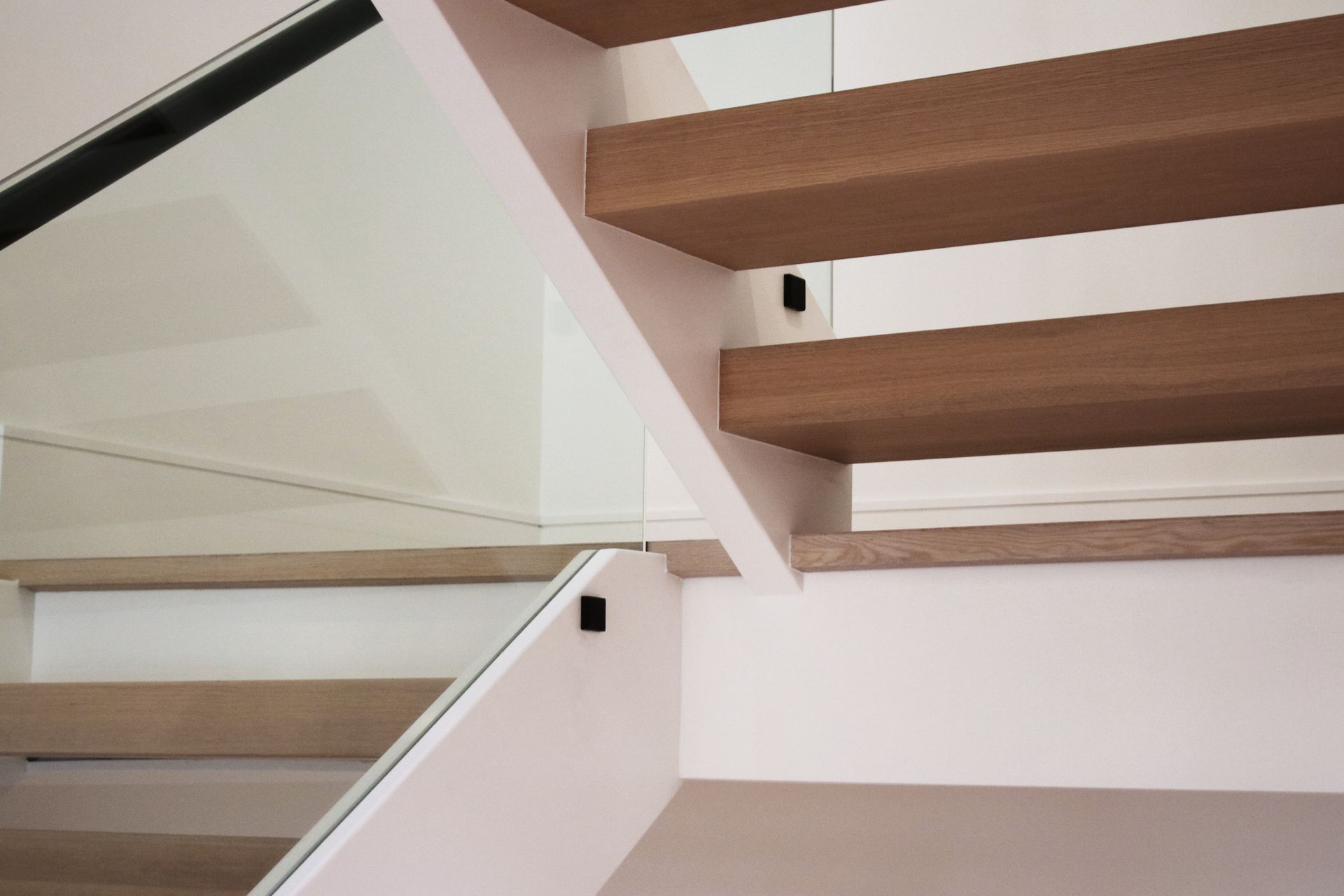 a staircase with wooden steps and a glass railing