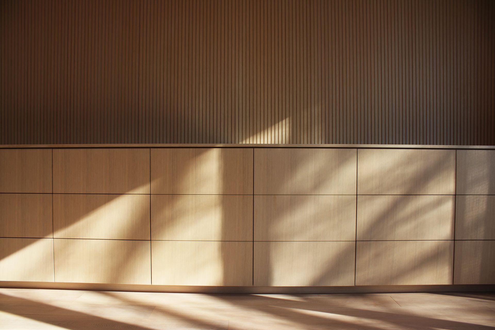 a kitchen with wooden cabinets and a wooden floor .