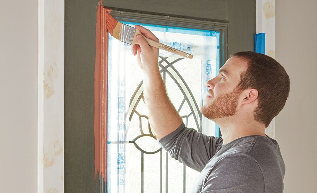 a man is using a drill on a wooden roof .