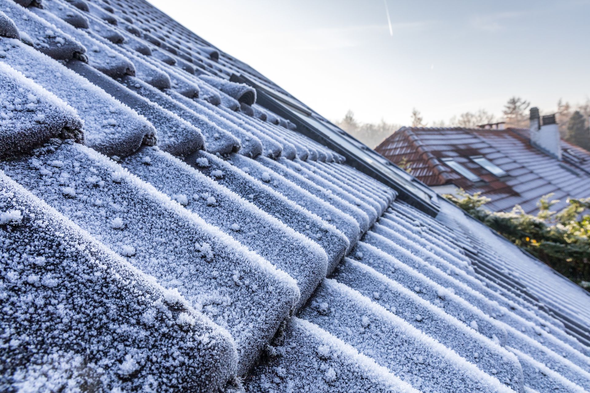 The Roof of A House Is Covered in Snow and Ice.