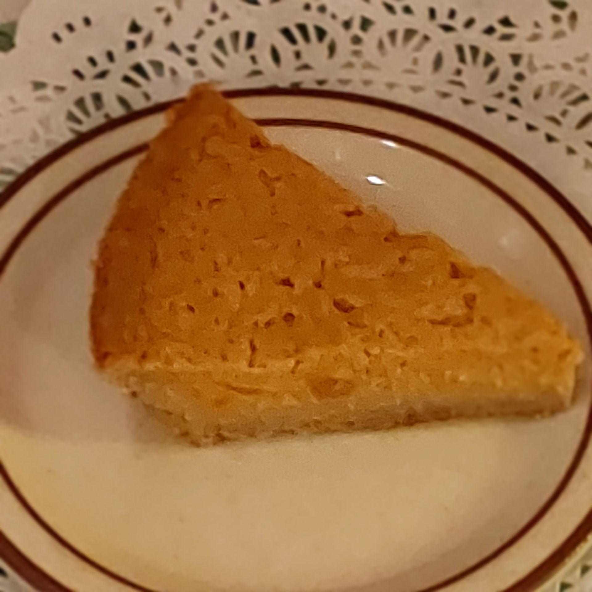 A slice of pie is on a white plate.