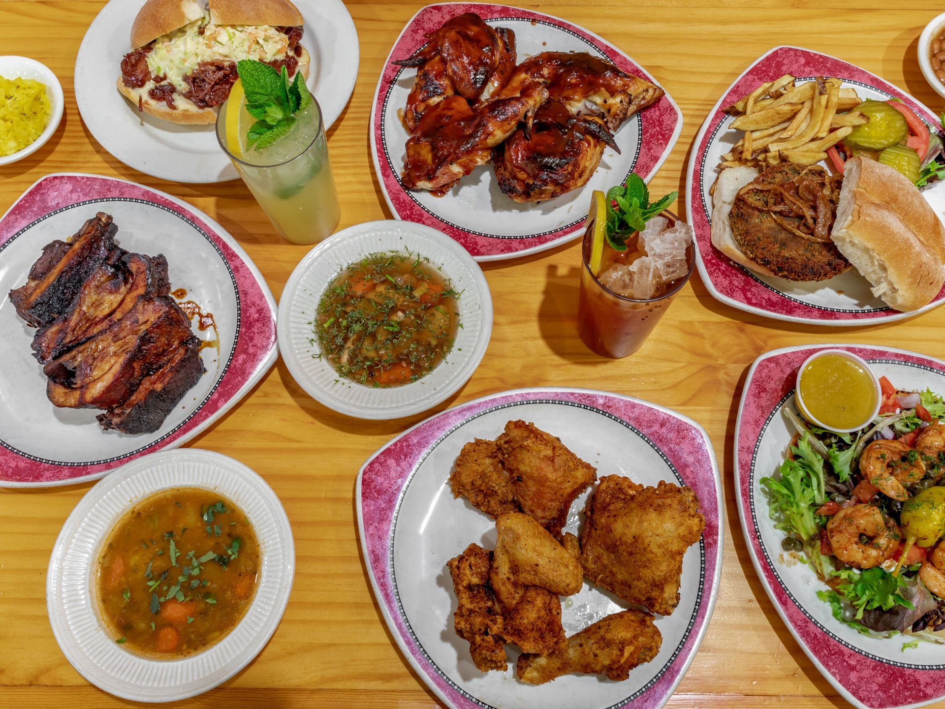 A table topped with plates of food and drinks.