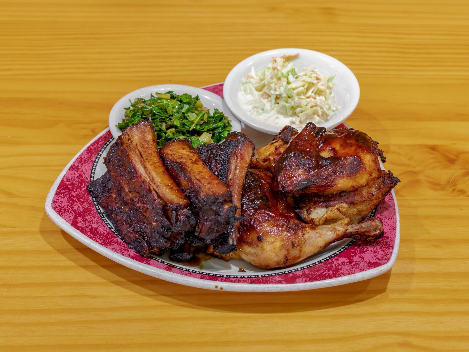A plate of meat and vegetables on a wooden table.