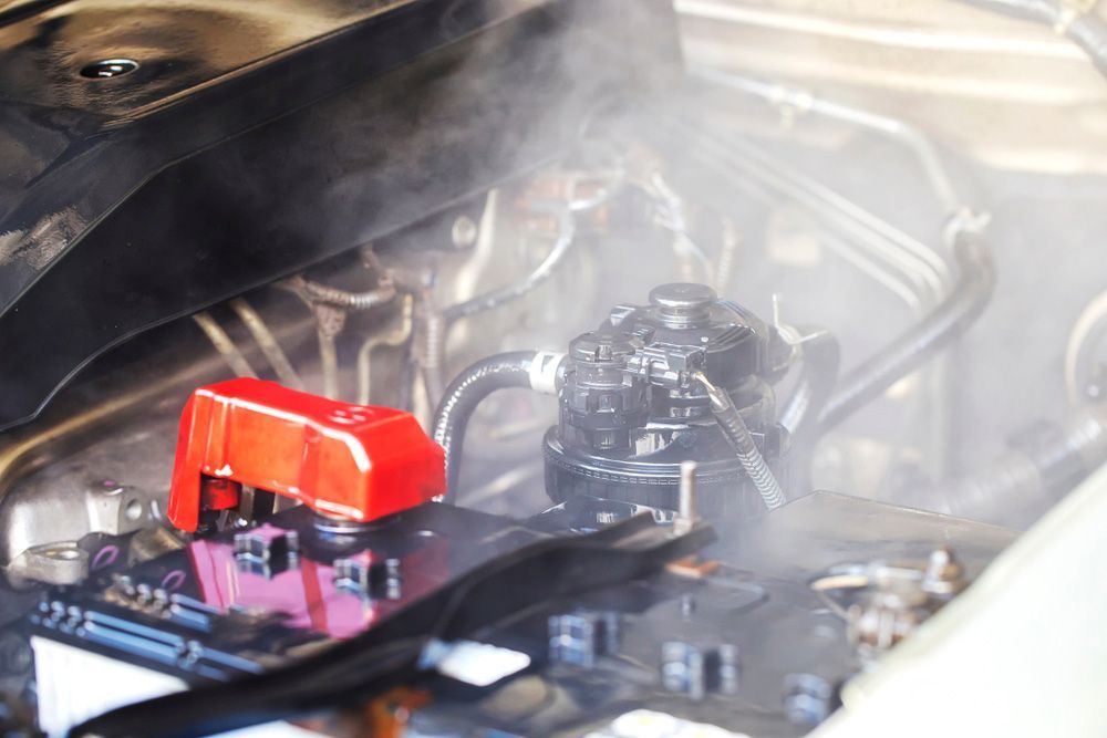 A Close Up Of A Car Engine With Steam Coming Out Of It — Bowen Automotive In Bowen, QLD