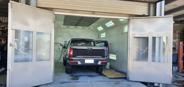 A Truck Parked Inside a Paint Booth With Open Doors — Bowen Automotive in Bowen, QLD