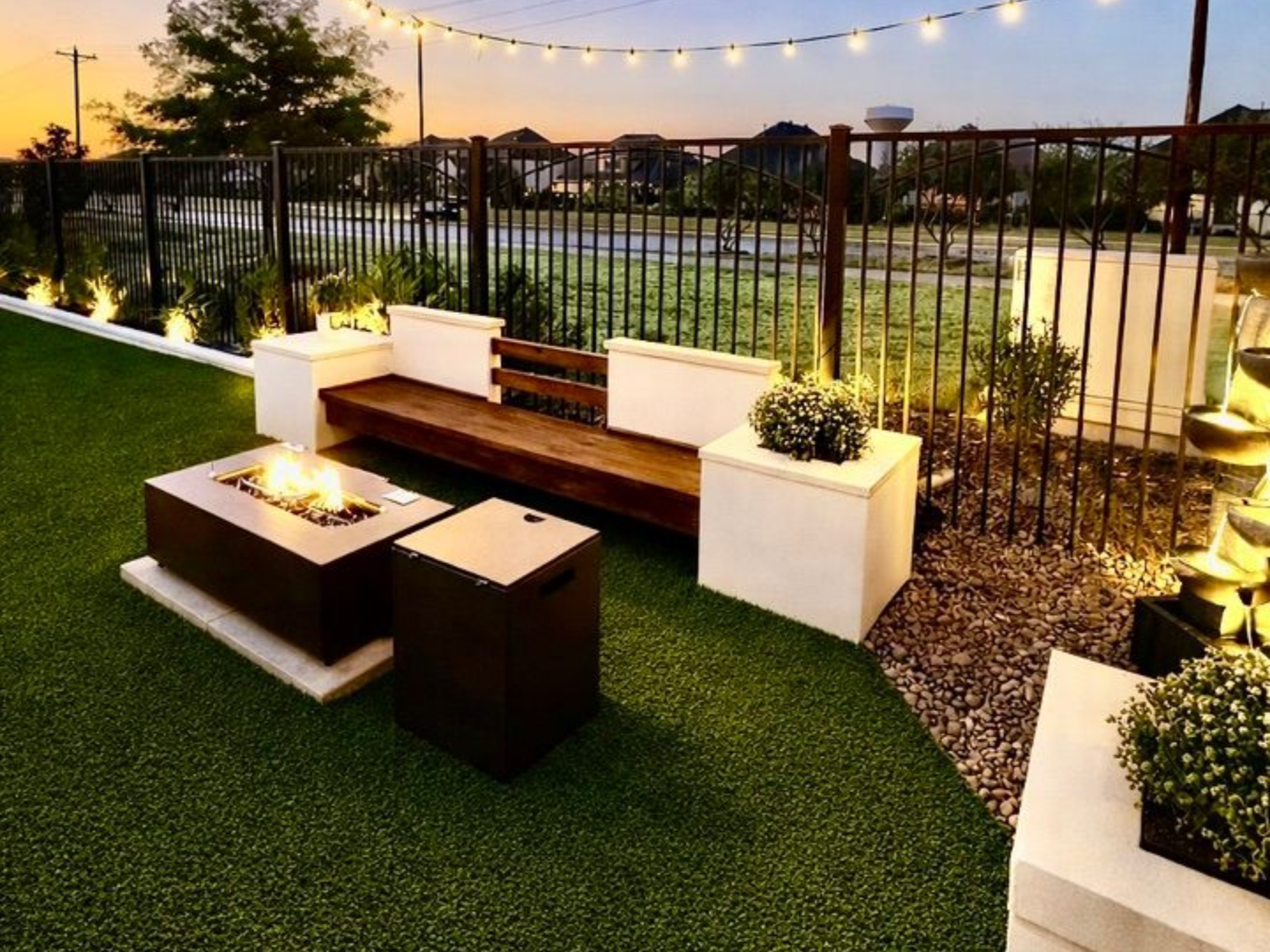 Modern home with a pool at dusk, reflecting the sky and lights; trees frame the background. Modern home with a pool at dusk, reflecting the sky and lights; trees frame the background.