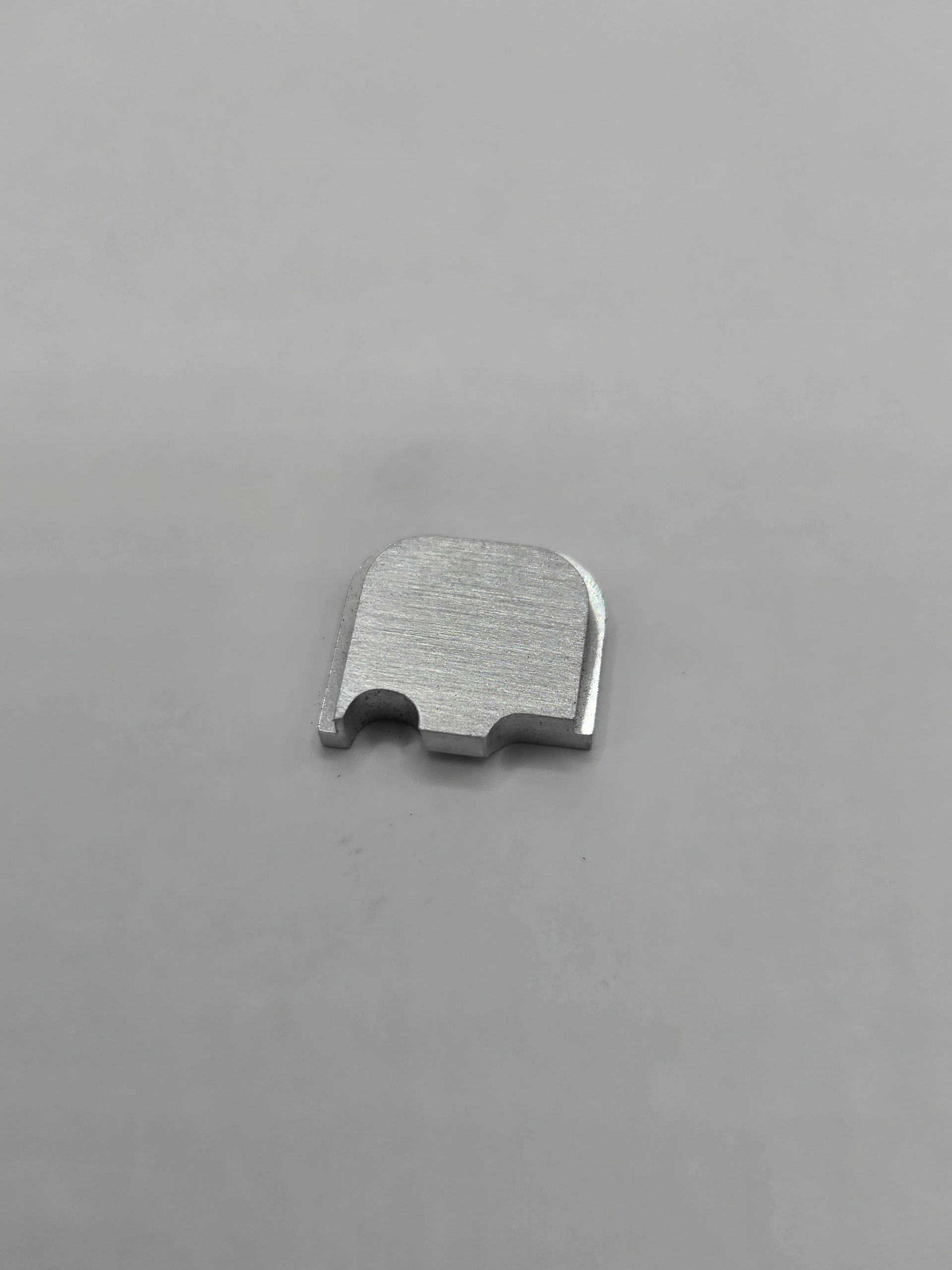 Silver rectangular plate with two notches.