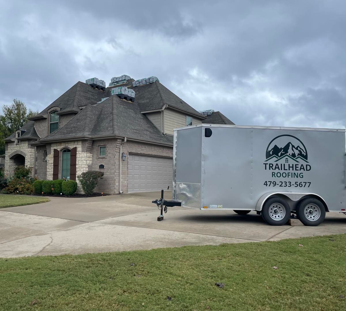 A trailer is parked in front of a house.