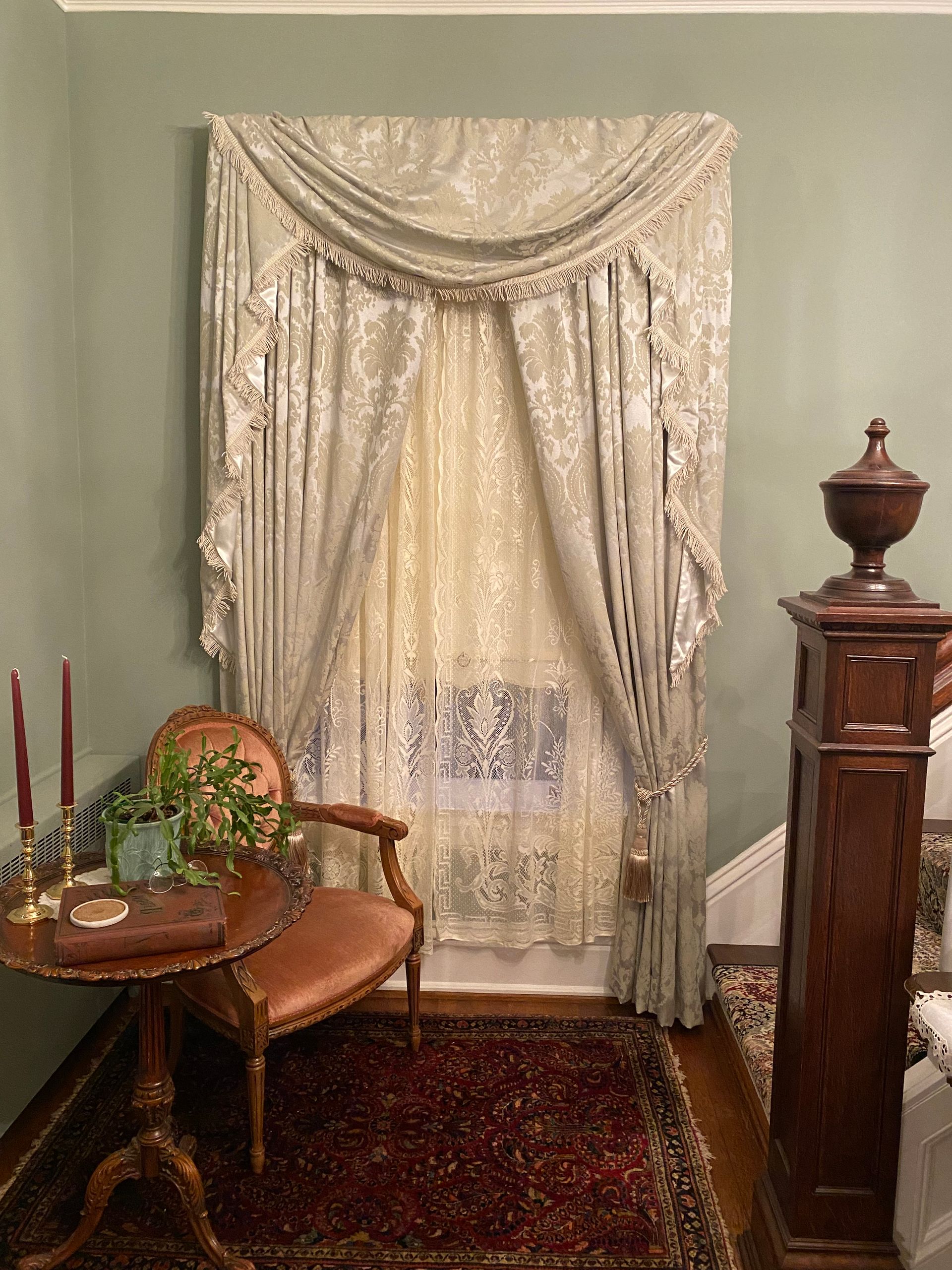 A living room with a chair , table , and clock.