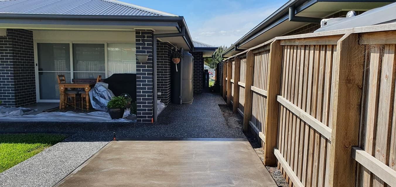 A concrete driveway leading to a concrete walkway — MidCoast Concreting in Mount George, NSW