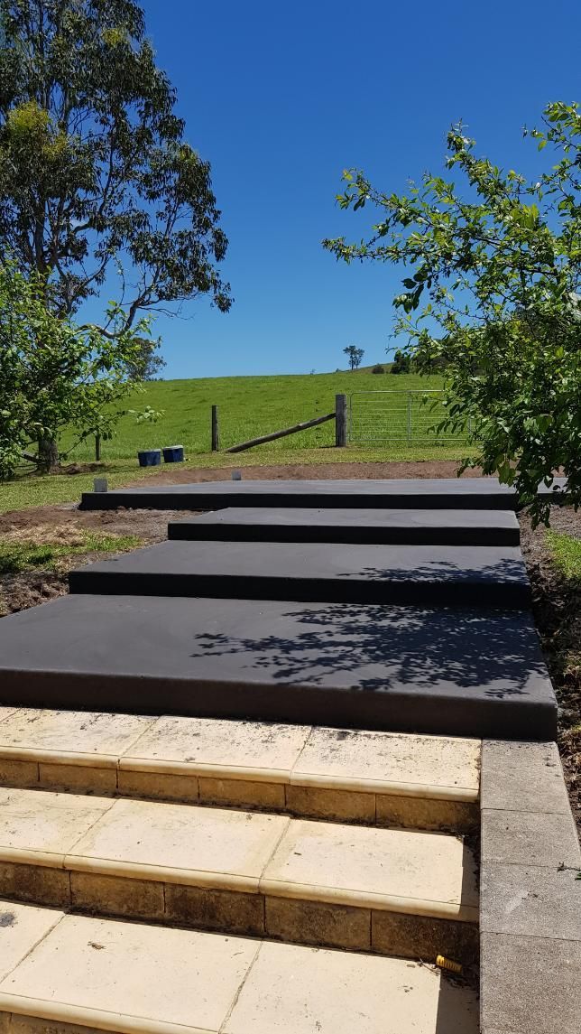 A Set of Stairs Leading Up to a Grassy Hill — MidCoast Concreting in Mount George, NSW
