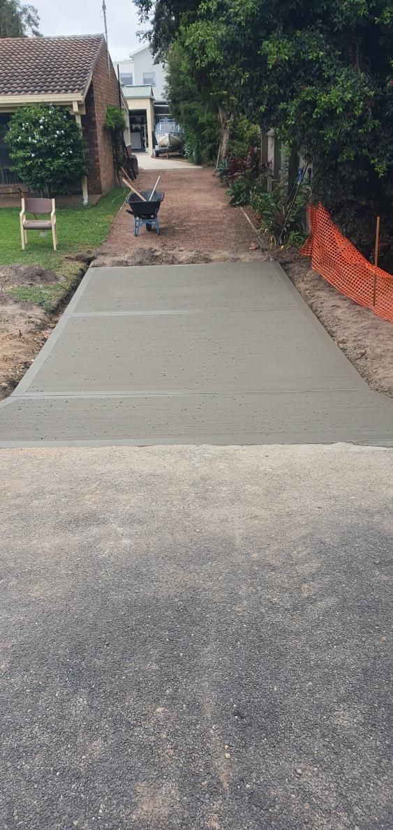 A Concrete Driveway is Being Built in Front of a House — MidCoast Concreting in Mount George, NSW