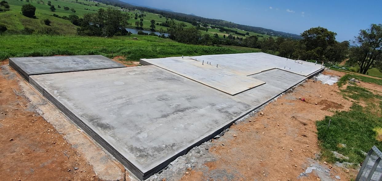 A Large Concrete Slab is Sitting on Top of a Dirt Field — MidCoast Concreting in Gloucester, NSW