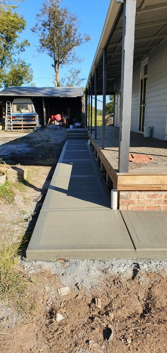 A concrete walkway is being built in front of a house. — MidCoast Concreting in Stroud, NSW