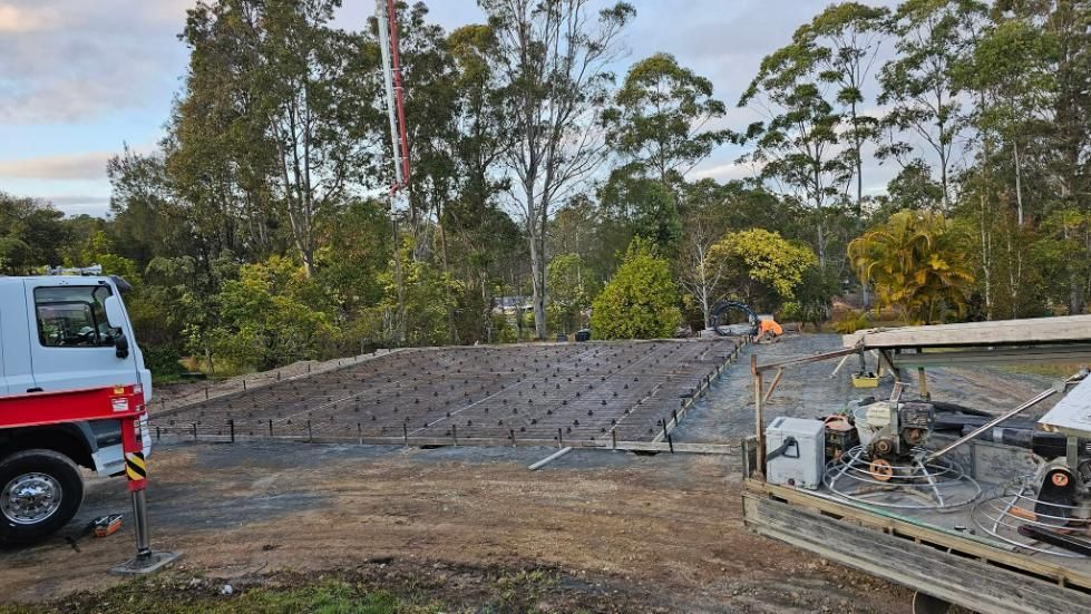 A White Truck is Parked in Front of a Construction Site — MidCoast Concreting in Forster, NSW