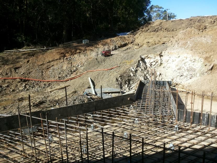 A Construction Site With a Fence and a Tractor in the Background — MidCoast Concreting in Mount George, NSW
