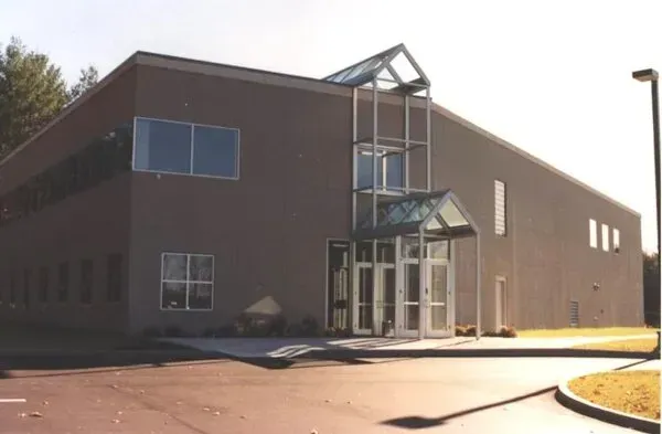 A large brown building with a glass entrance.