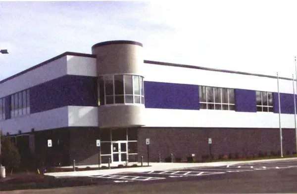 A large building with blue and white stripes on the side.
