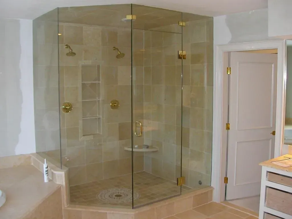A bathroom with a walk in shower and a sink.