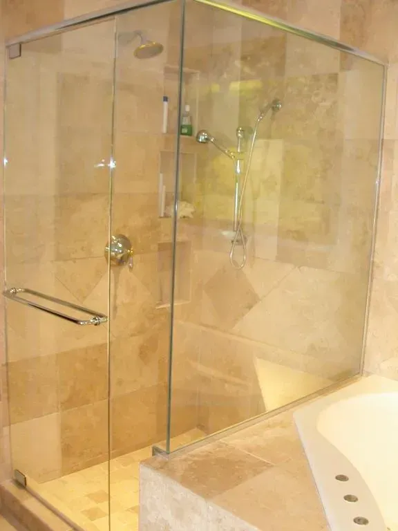 A bathroom with a walk in shower and a bathtub.