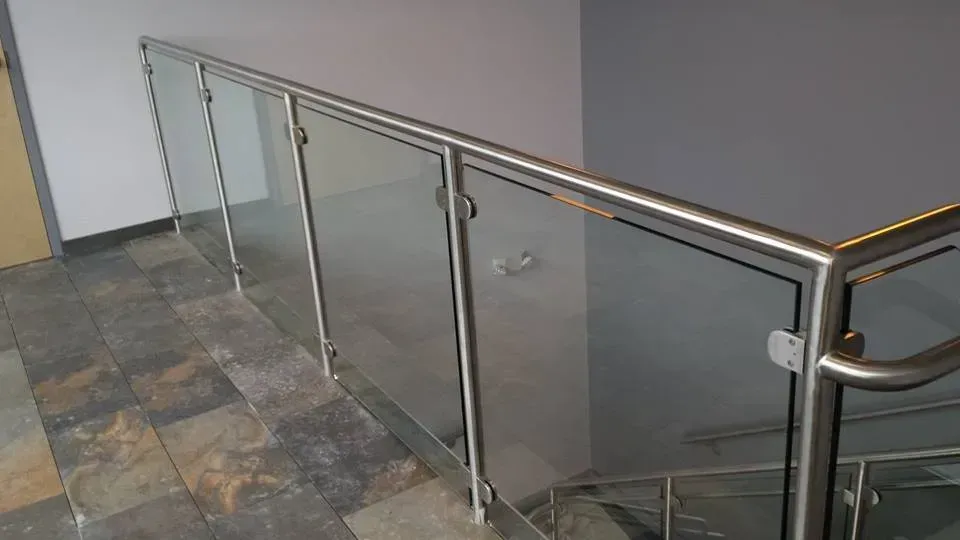 A staircase with a glass railing and a stainless steel railing.