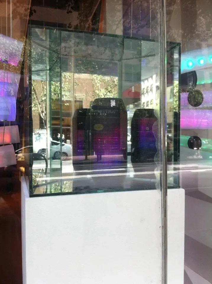 A glass display case with a purple item in it.