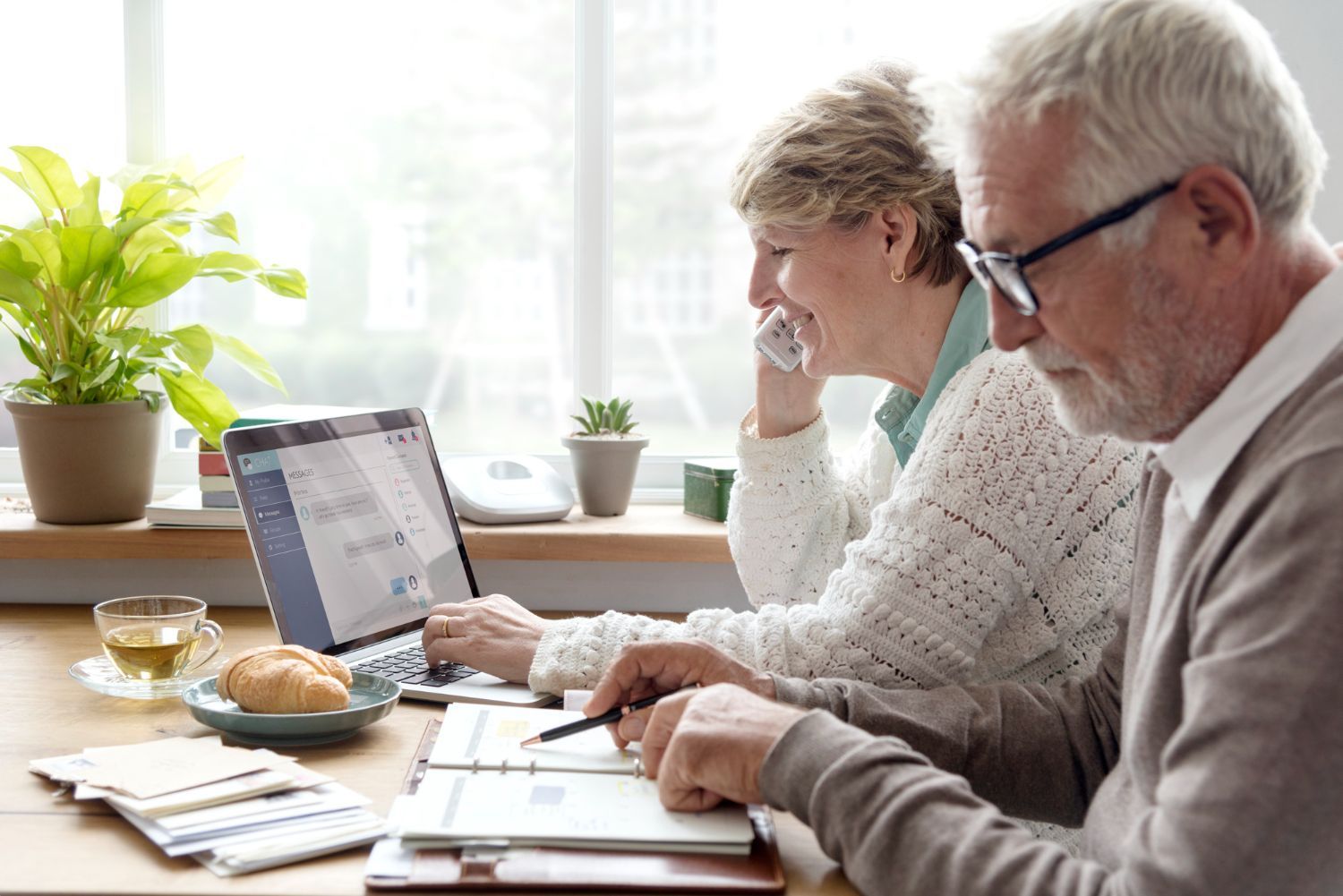 Business team reviewing financial chart, pointing to data on a paper.