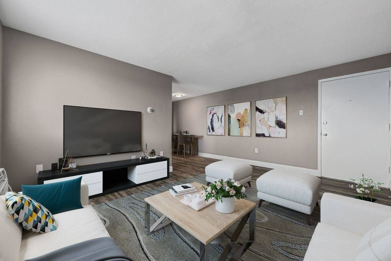 A picture of Southglenn Place's spacious living room with furniture, rug, wall art, and more!