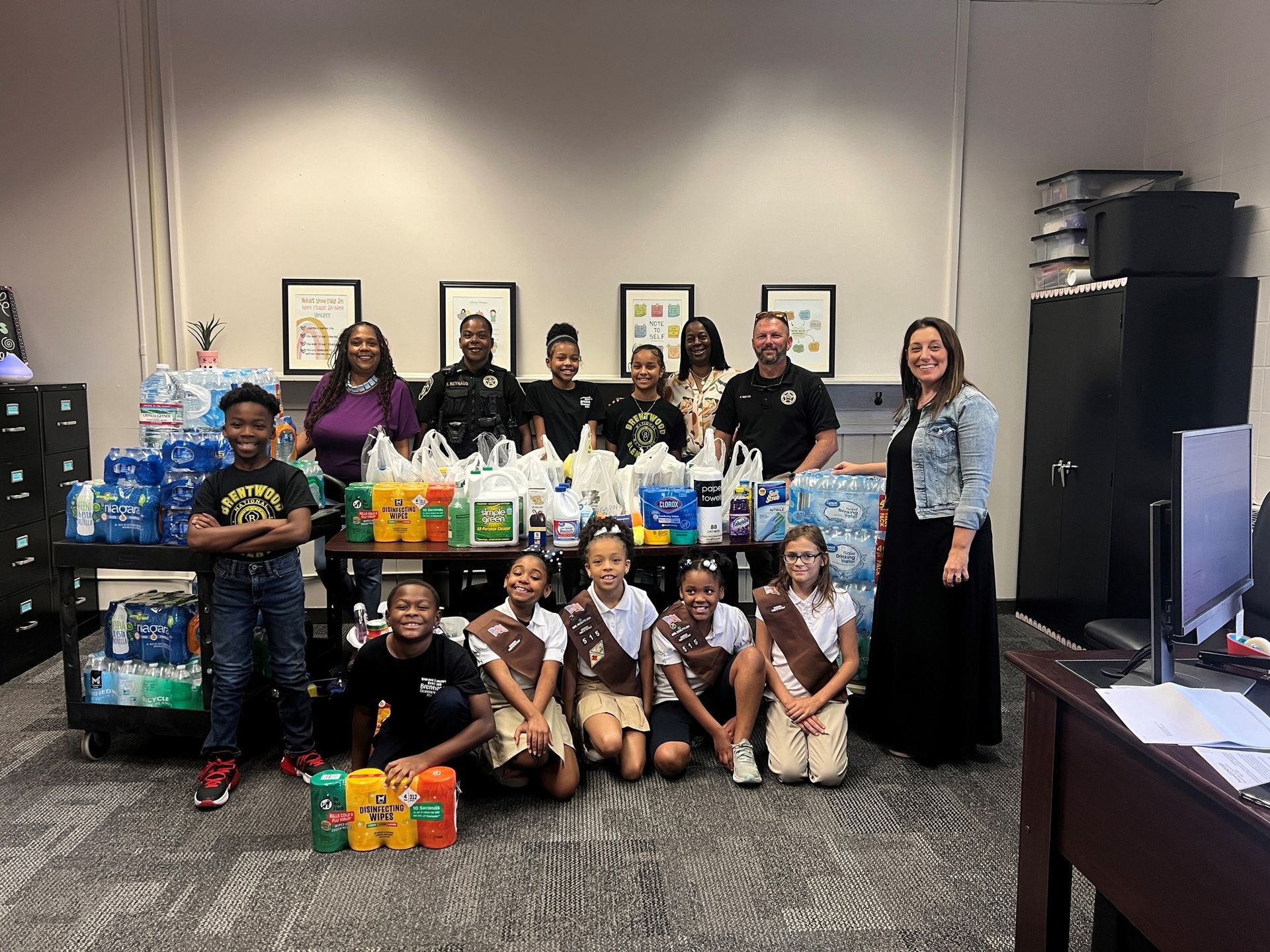 A group of girl scouts are posing for a picture in a room.