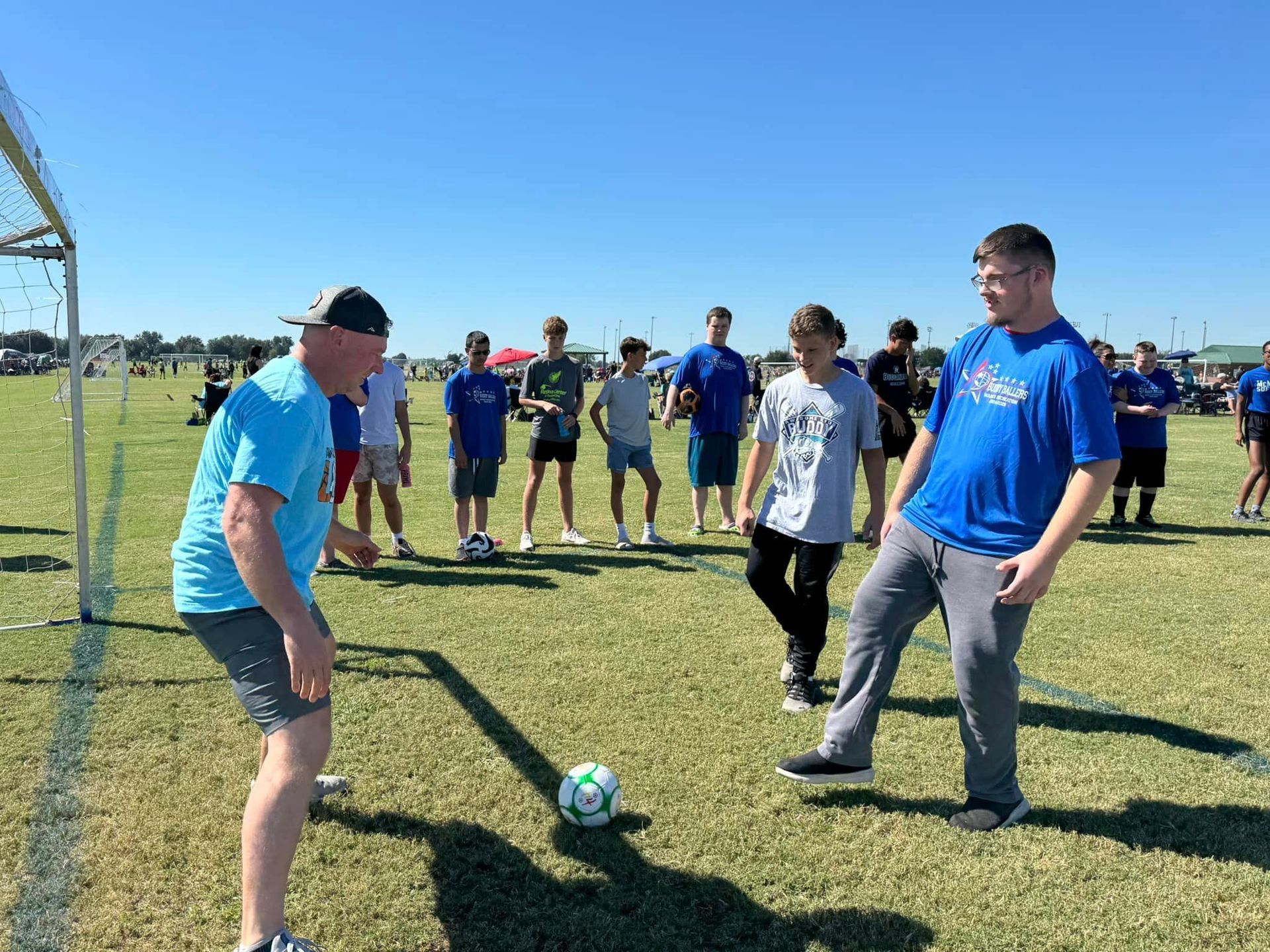 A group of people are playing soccer on a field.