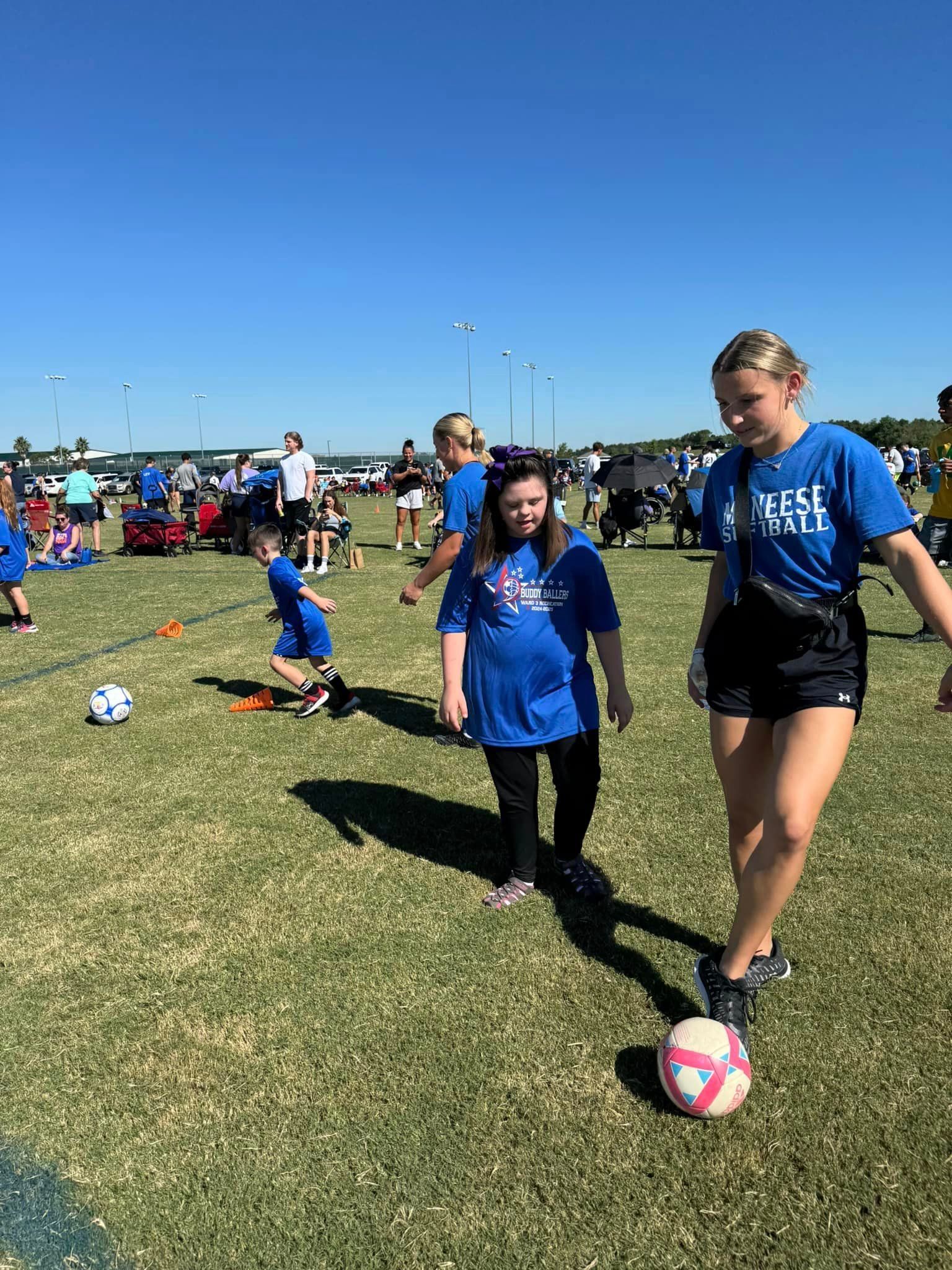 A group of people are playing soccer on a field.