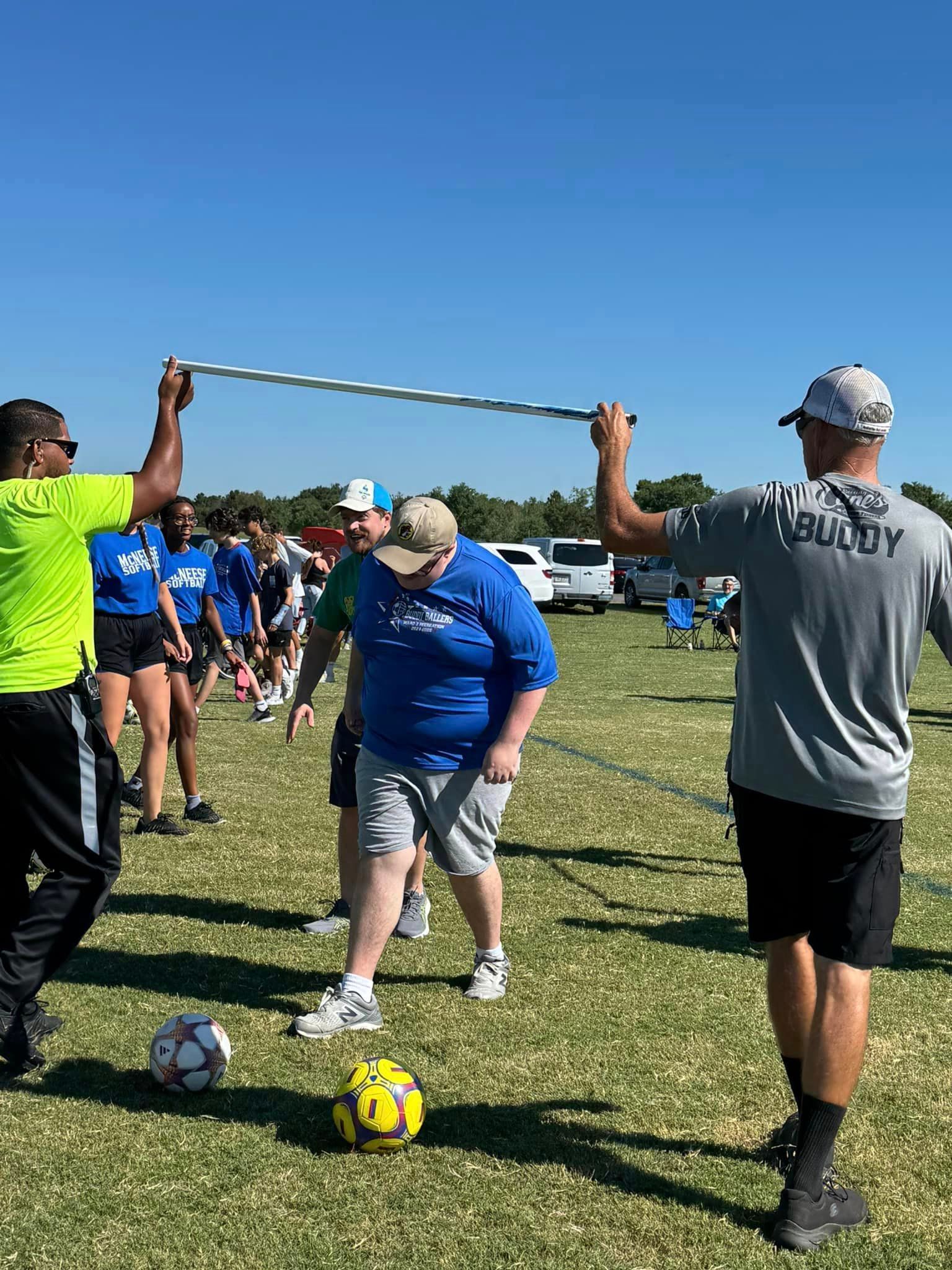 A group of people are playing soccer on a field.