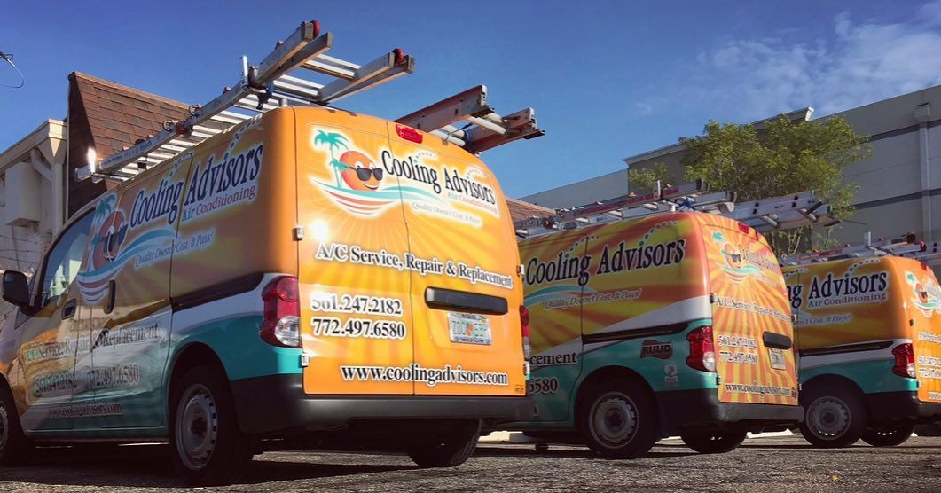 Three orange, teal, and white service vans with ladders parked, advertising a pool service.