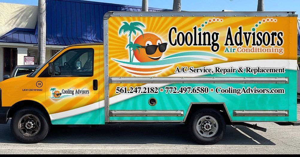 Yellow and teal Cooling Advisors AC service truck with orange logo and contact info.
