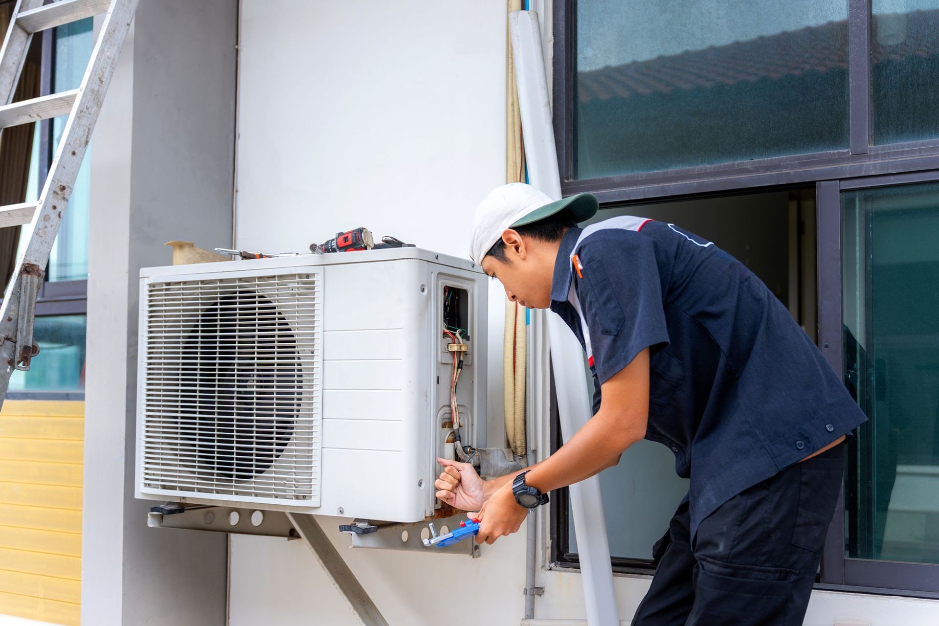 An HVAC technician performing professional AC repair and maintenance on an outdoor unit