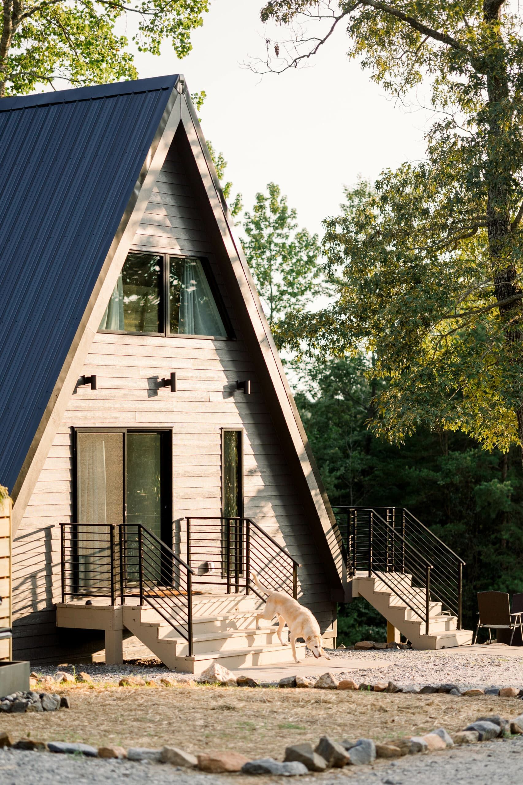 A small a frame house with a blue roof and stairs